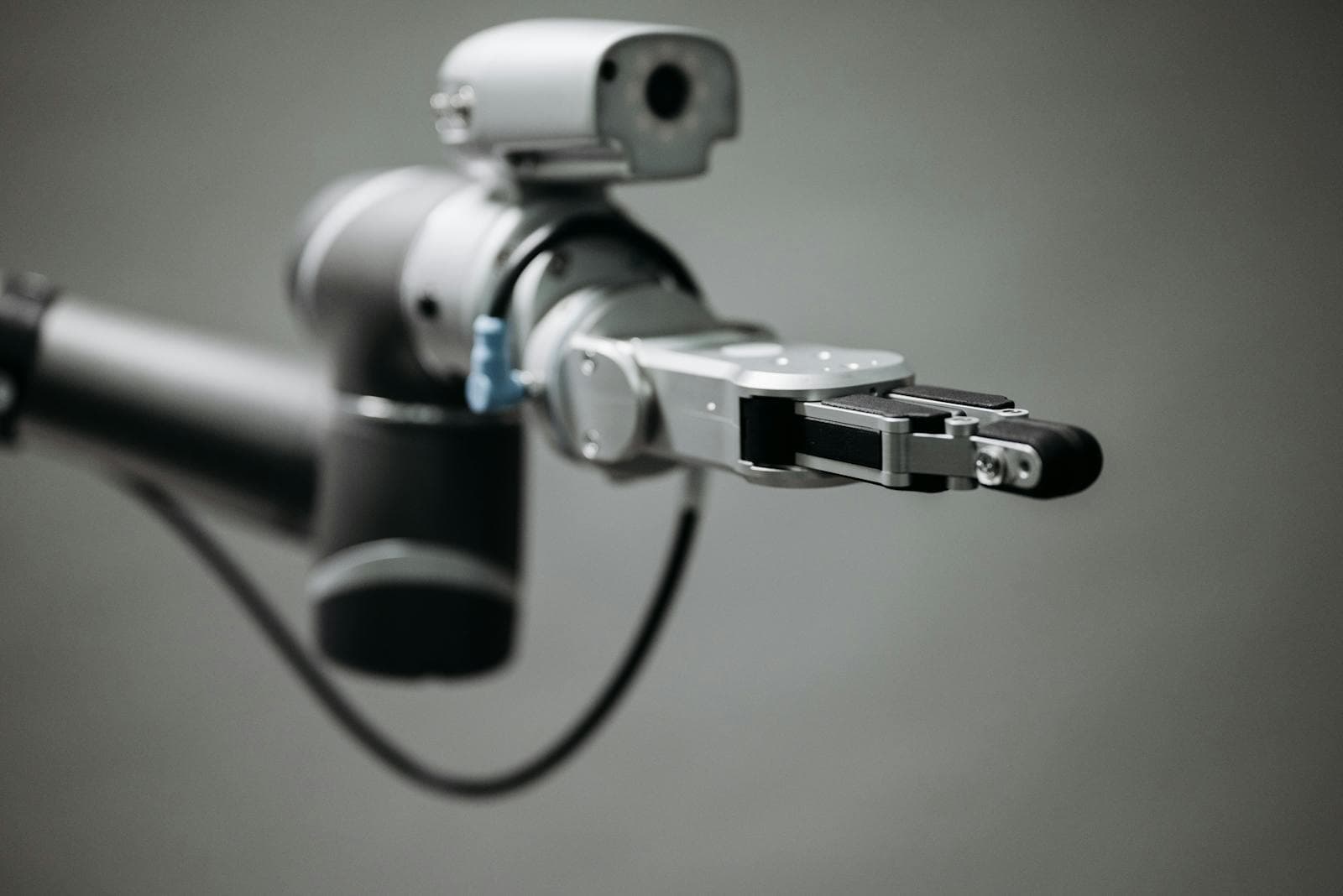 Close-up of a robotic gripper on a grey background